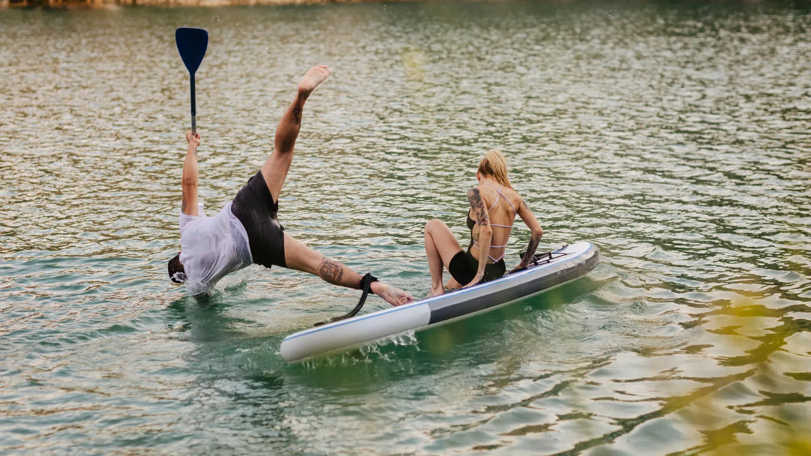 Paddler falling off an inflatable paddle board