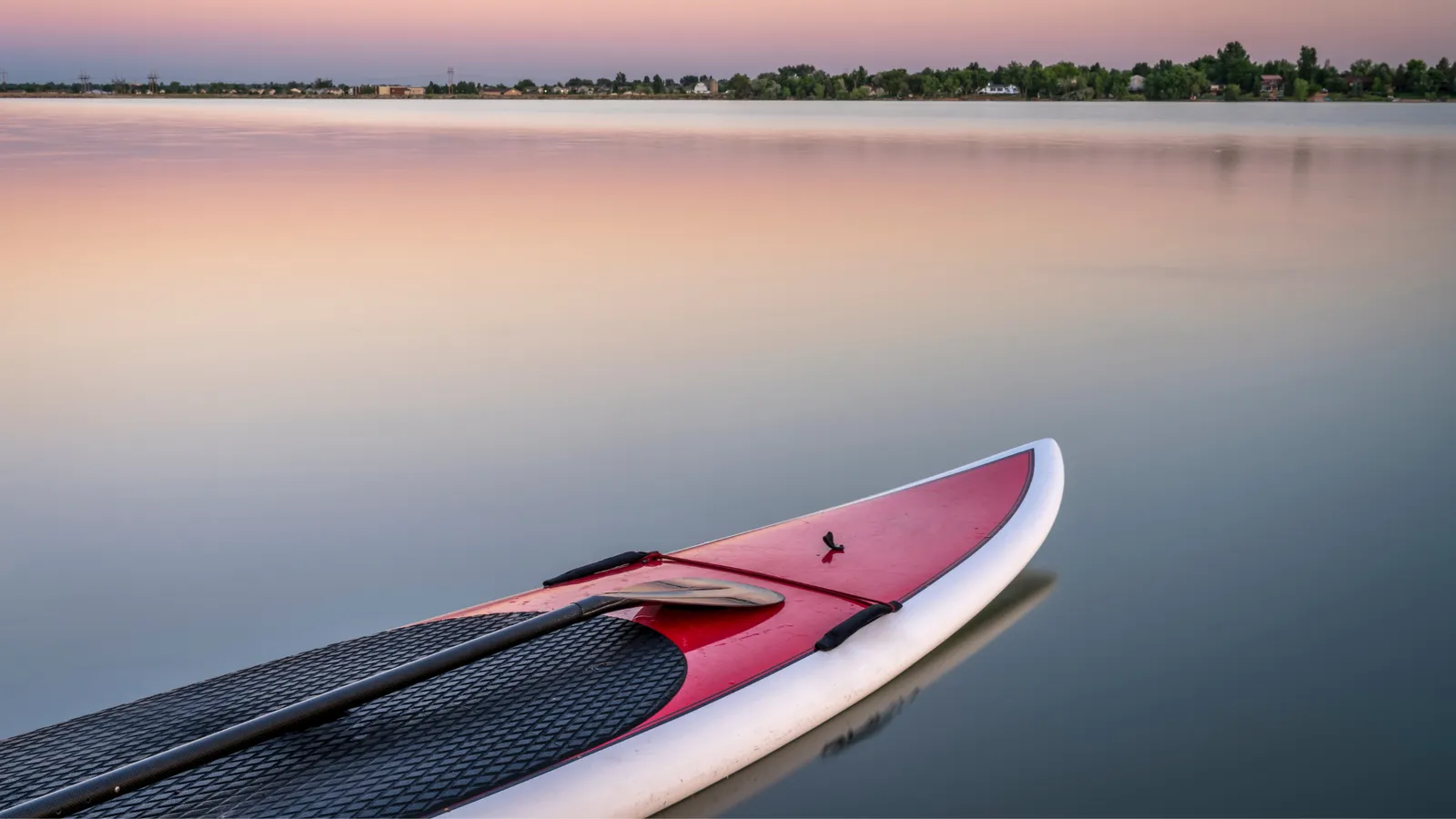 Stand up paddle boarder on calm water