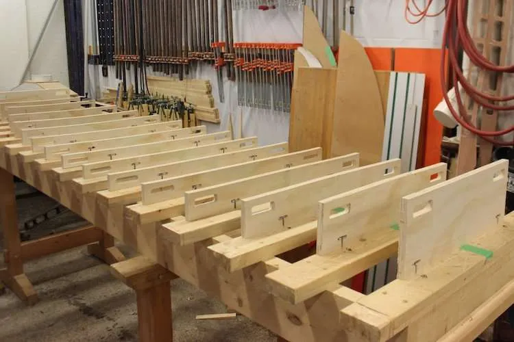 Hollow wooden paddle board on a rocker table during the build