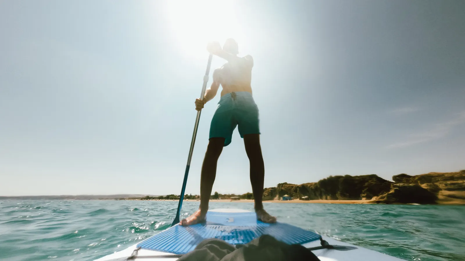 Paddle boarder using a long, efficient stroke to go faster